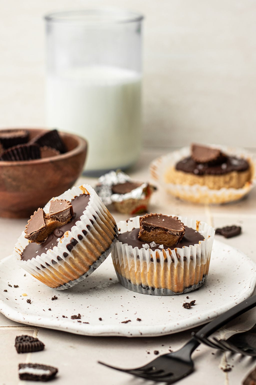 Two peanut butter cheesecake mini bites in cupcake liners.