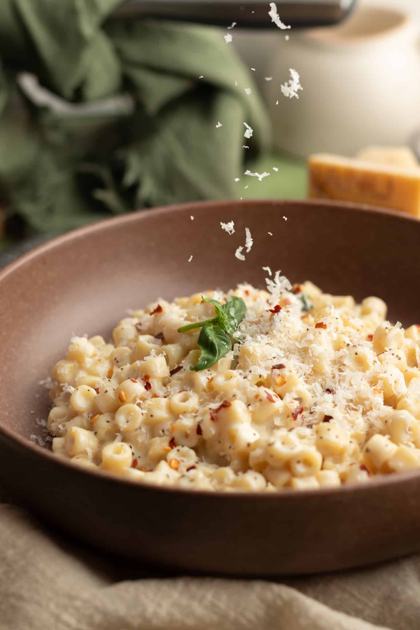 Picture of freshly grated parmesan cheese sprinkled on top of boursin pasta for garnish.