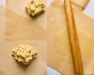 Dividing lemonade cookie dough into two then rolling in between two pieces of parchment paper with wooden rolling pin.