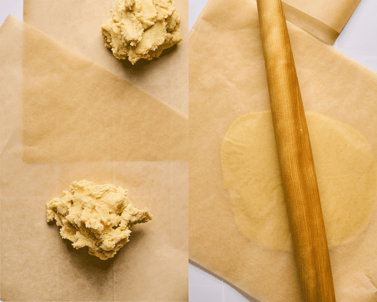 Dividing lemonade cookie dough into two then rolling in between two pieces of parchment paper with wooden rolling pin.