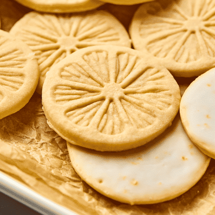 Upclose image of lemonades cookie on parchment-lined baking tray.
