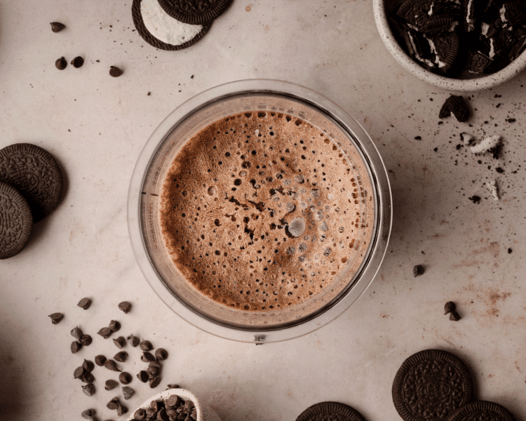 Chocolate ice cream frozen in ninja creami pint container after freezing for 24 hours.
