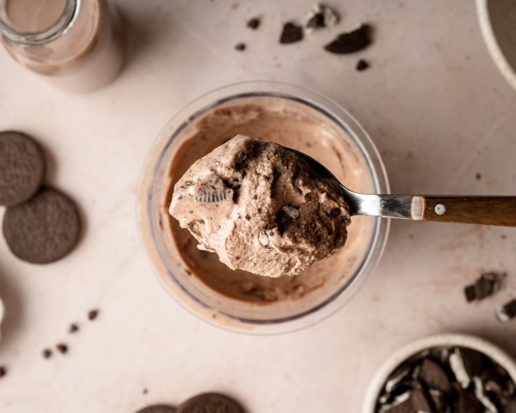 Upclose image of chocolate oreo ice cream on spoon scooping out of ninja creami container.