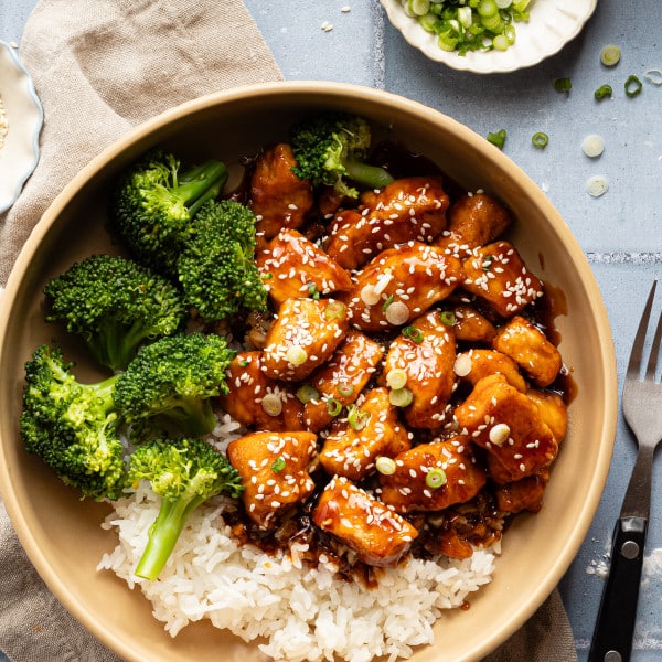 Honey garlic chicken in bowl with rice and broccoli.