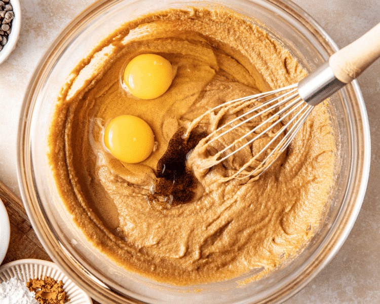 Whisking in the eggs and vanilla to the wet ingredients.