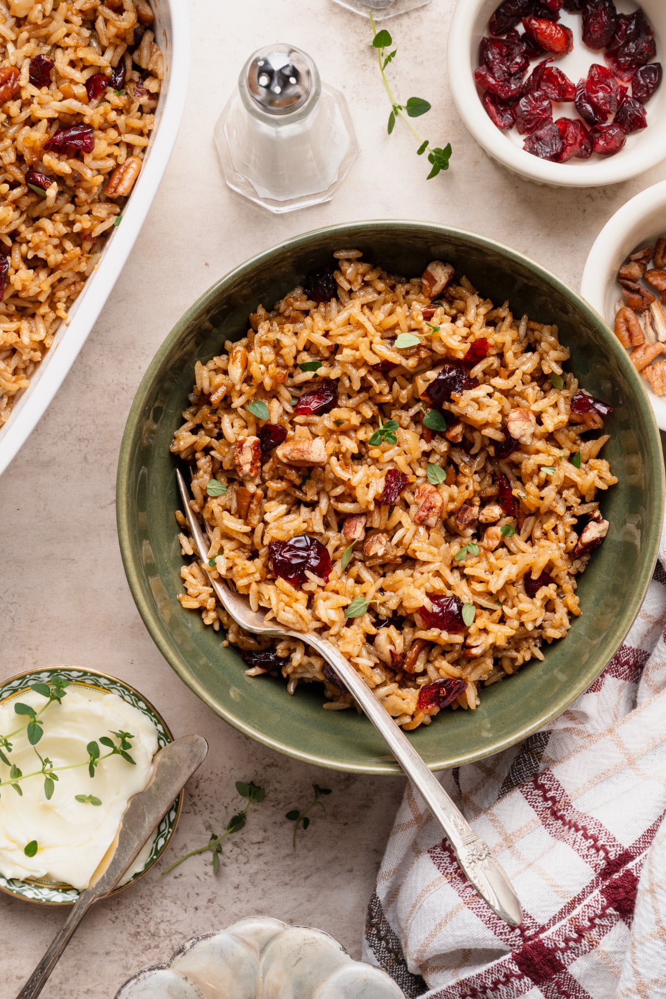Holiday stick of butter rice in a green bowl with fork.