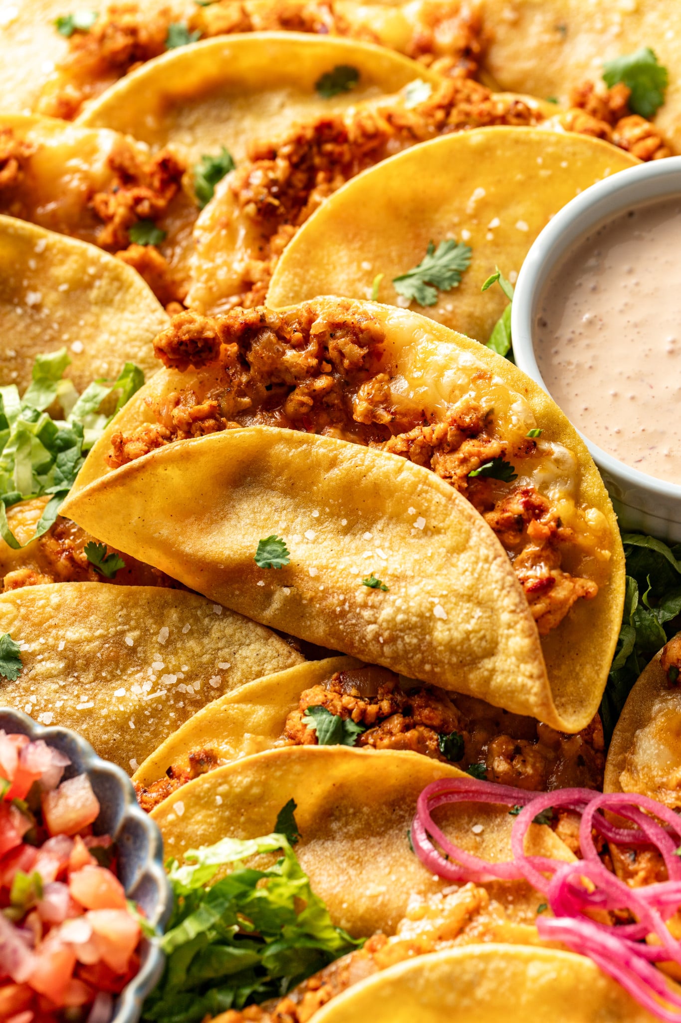 Ground chicken taco baked and set on top of tray of more baked chicken tacos.
