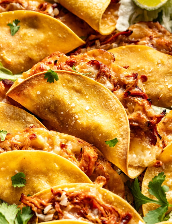 Honey chipotle chicken tacos baked and piled on top on each other.