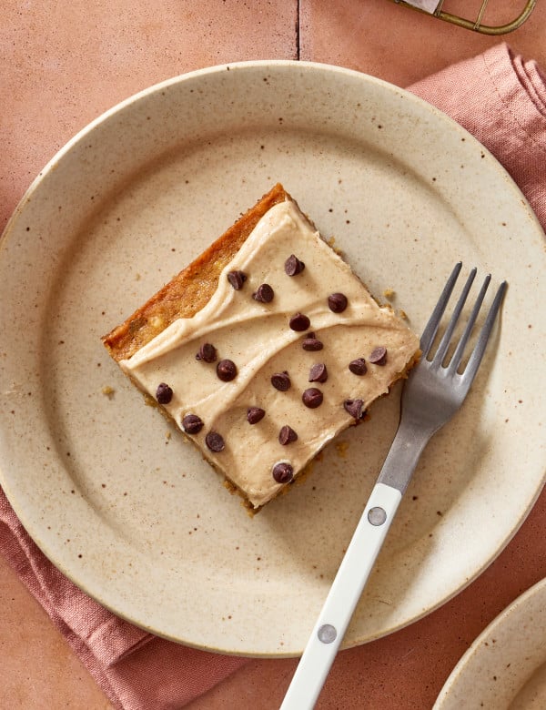 Banana chocolate chip bar cut and placed on plate with a fork.