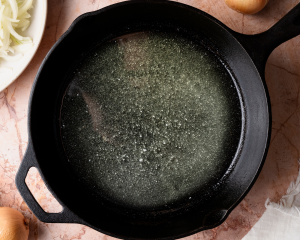 Melting the butter and olive oil in a cast-iron pan.