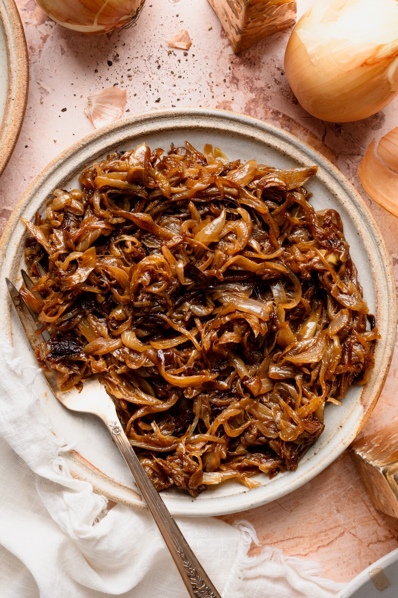 Caramelized onions on a plate with a fork.