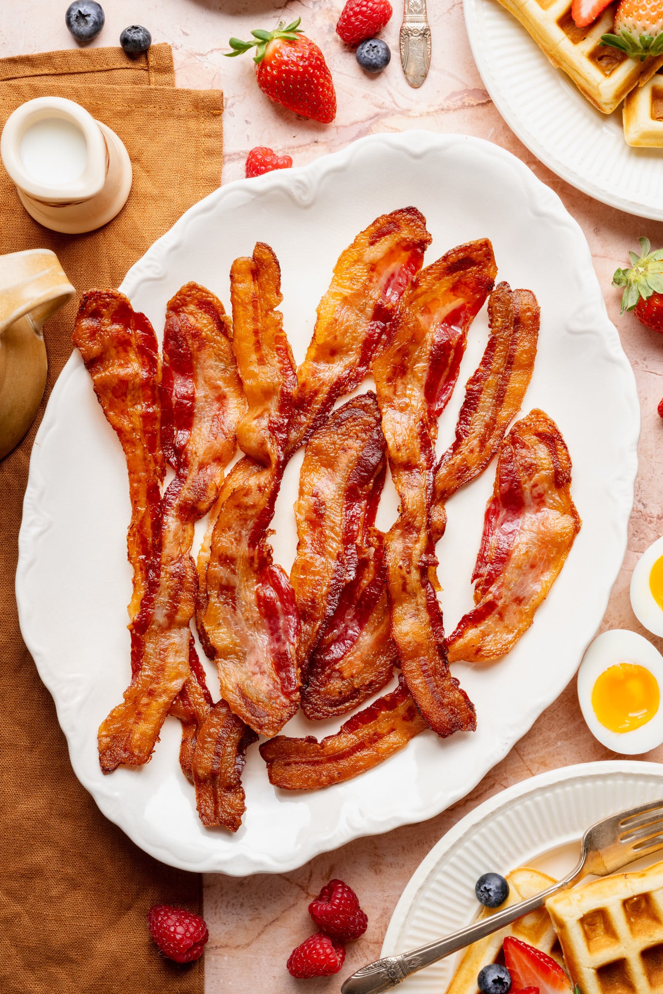 Bacon cooked and served on white plate.