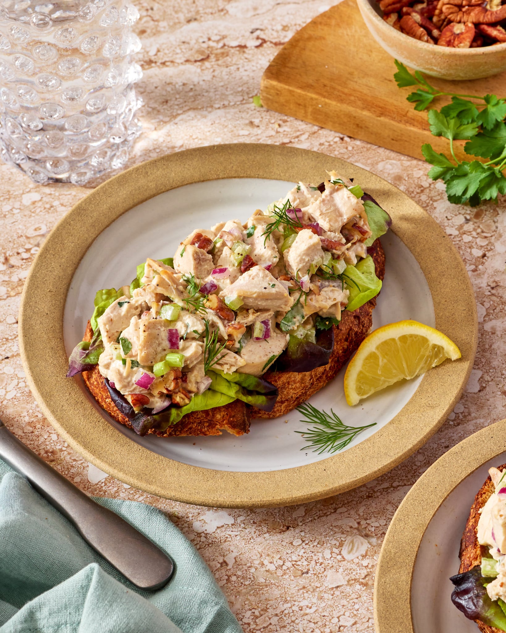 Everyday chicken salad recipe served on top of toast on a small plate.