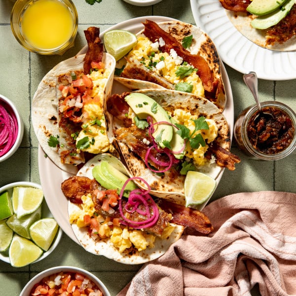 Loaded breakfast tacos assembled on large serving plate.