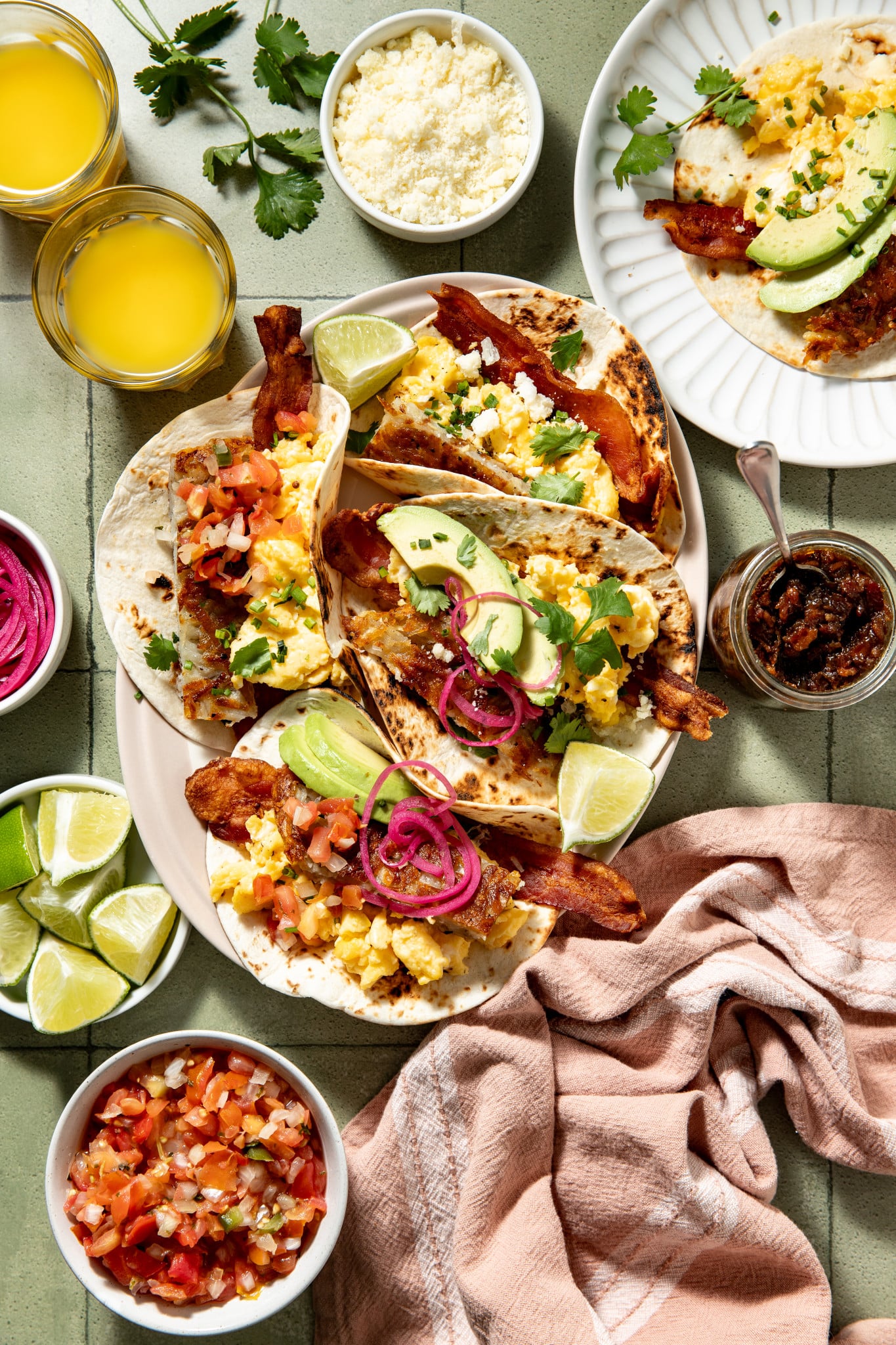 Loaded breakfast tacos assembled on large serving plate.