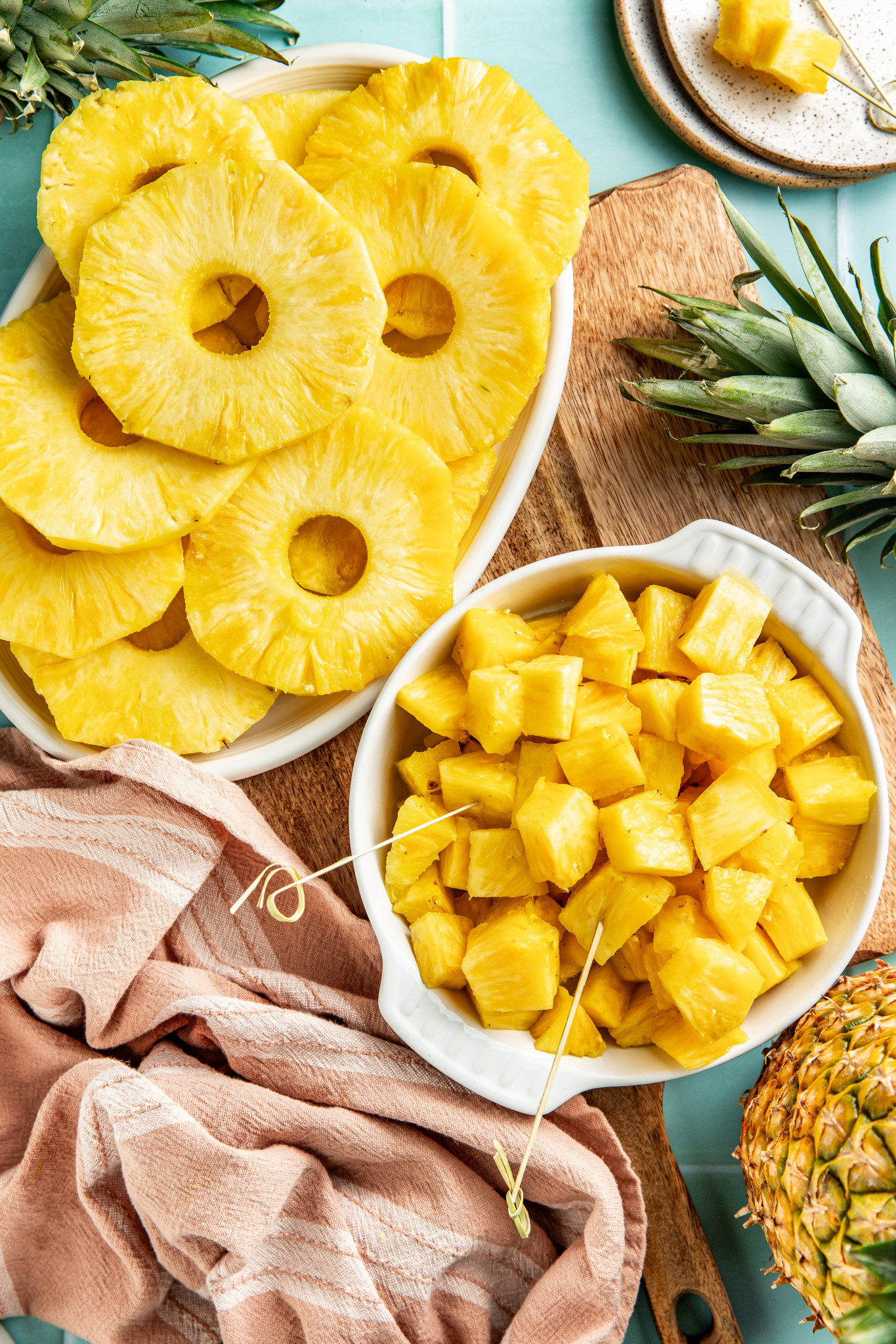 Fresh pineapple chunks and rings sliced and set beside each other.