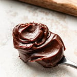 Thick chocolate ganache on a spoon.