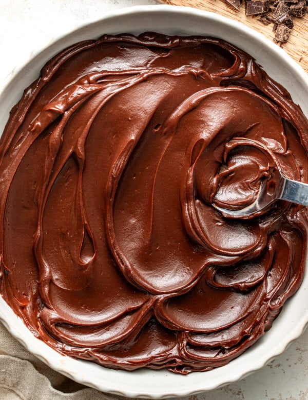 Chocolate ganache in a large serving bowl with spoon