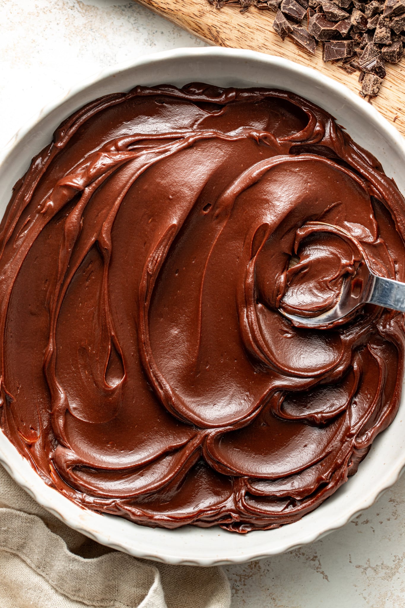 Chocolate ganache in a large serving bowl with spoon