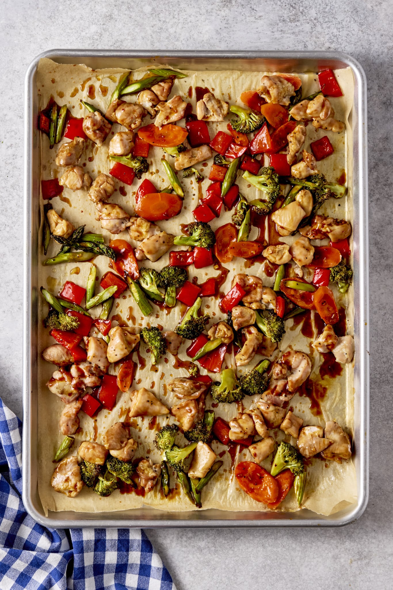 Sesame chicken and veggies baked on sheet pan.