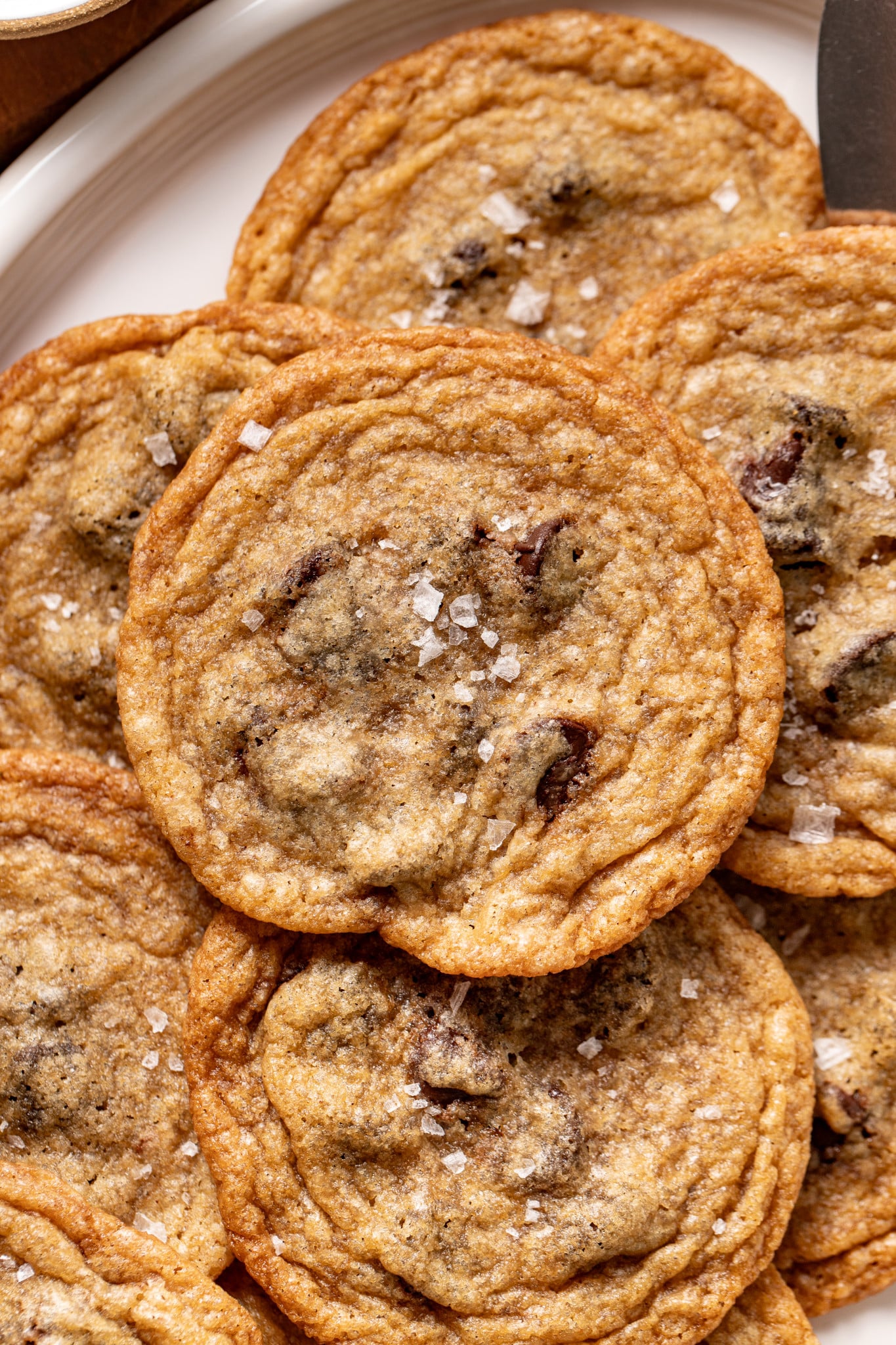 Upclose photo of tate's copycat chocolate chip cookie sprinkled with flake salt.