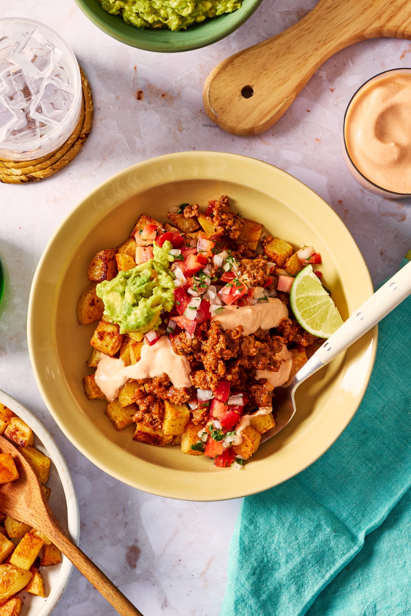 Potato taco bowl with all the toppings and a fork digging into the bowl.