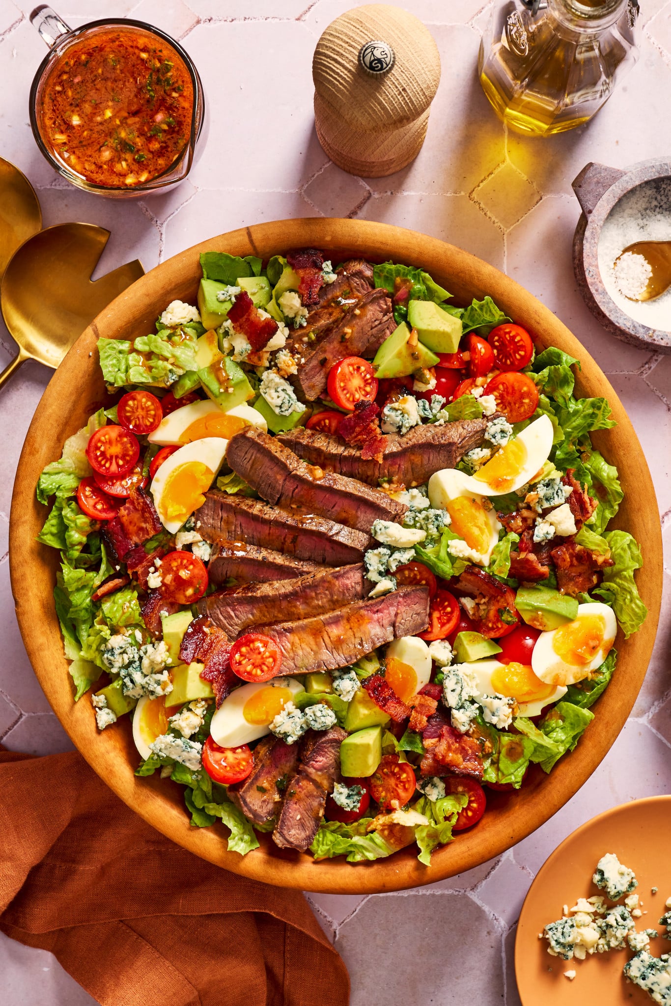Steak cobb salad with BBQ vinaigrette in wood serving bowl.