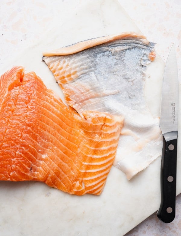 Salmon with skin removed using knife method.