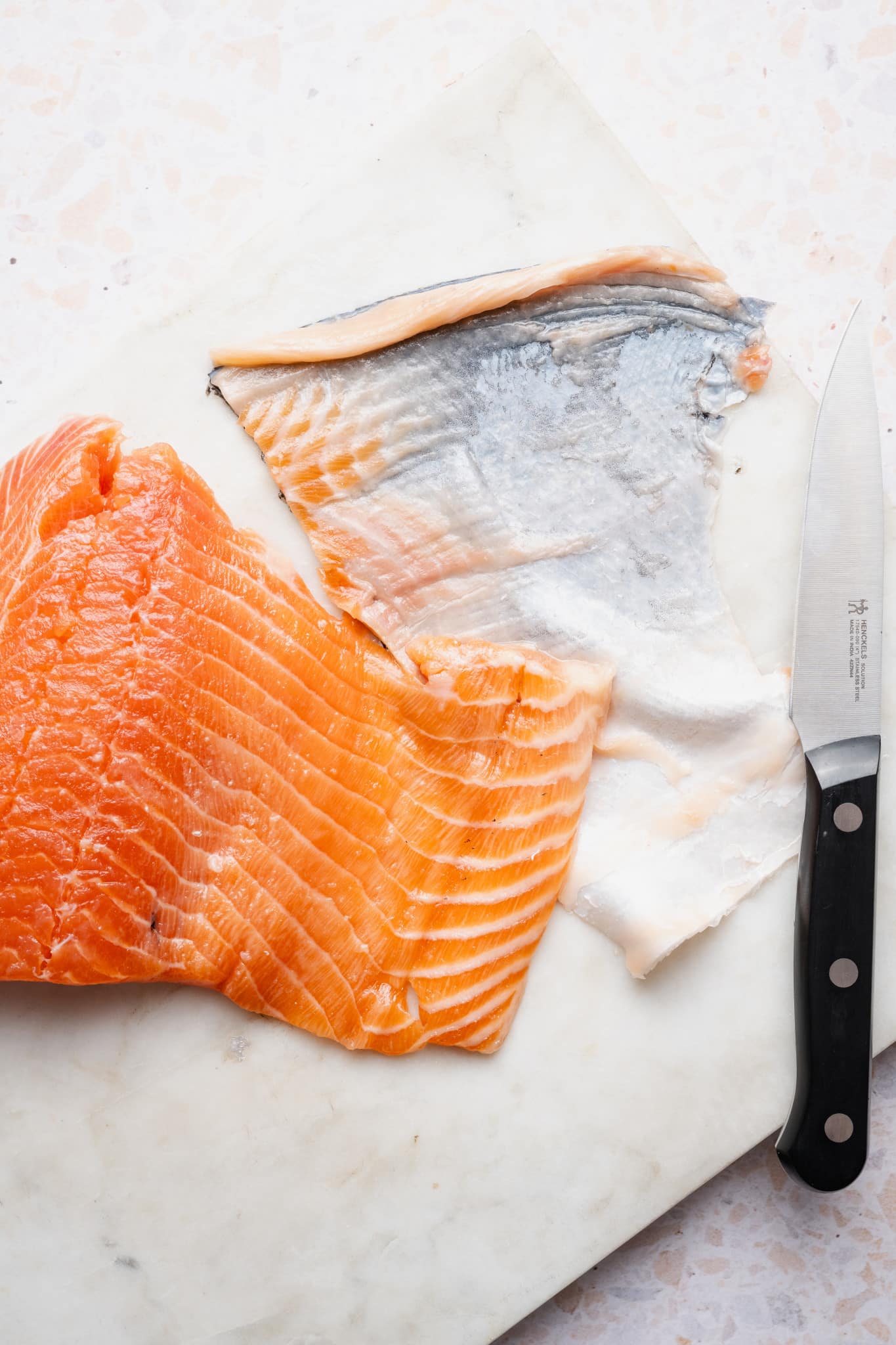 Salmon with skin removed using knife method.